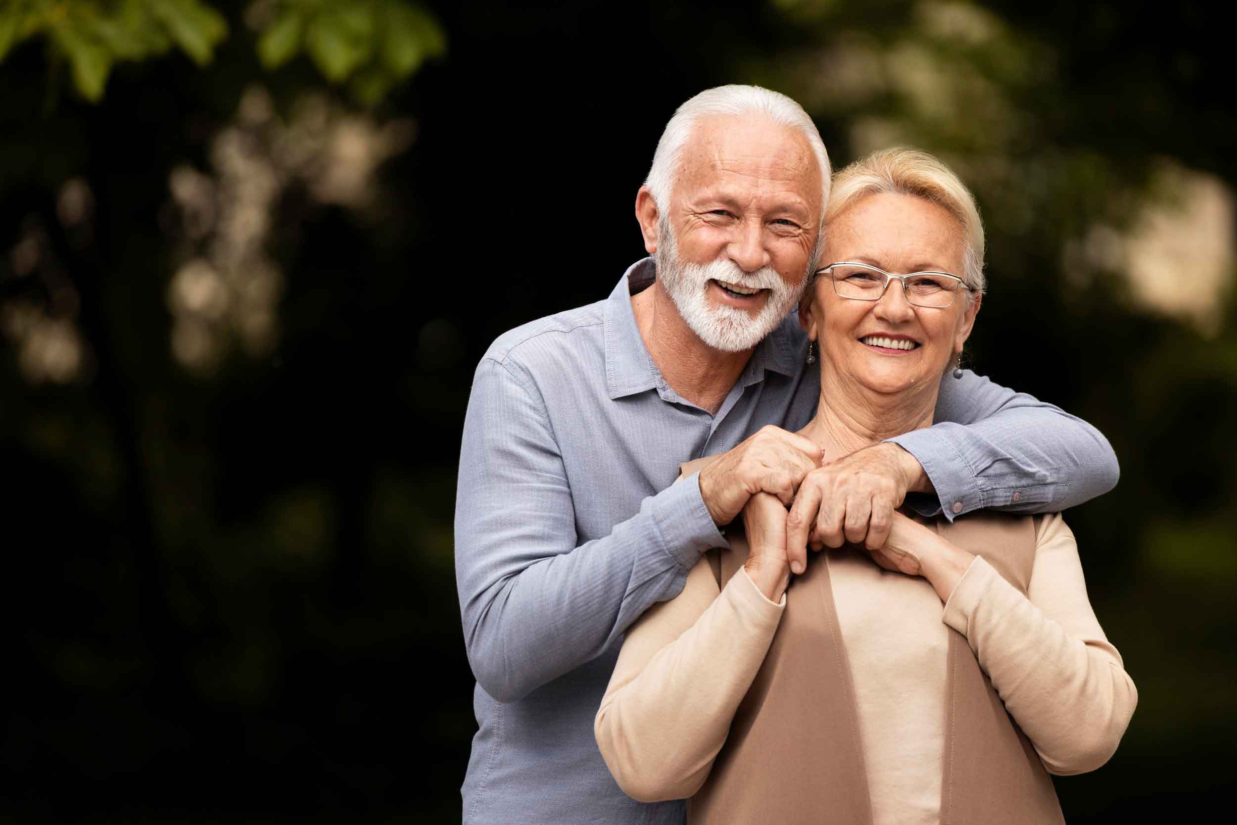 Old couple smiling and posing together